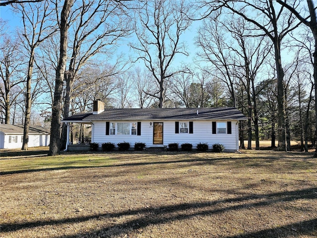 ranch-style house with a chimney and a front yard