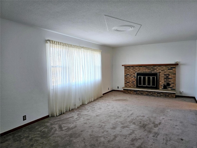 unfurnished living room with carpet, a fireplace, baseboards, and a textured ceiling