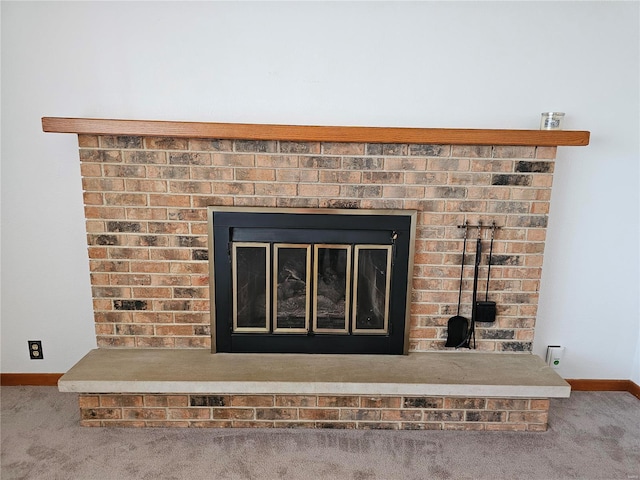 details with baseboards, carpet floors, and a fireplace