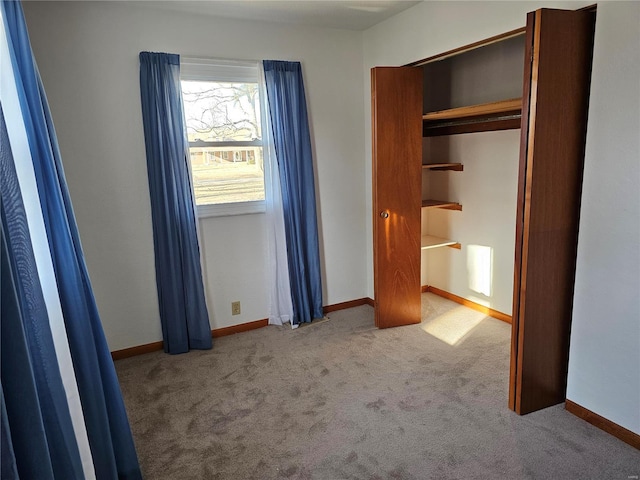 unfurnished bedroom featuring baseboards and carpet flooring