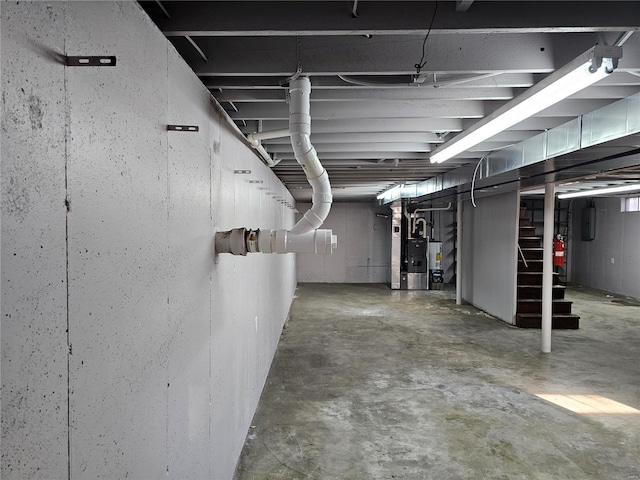 unfinished basement with electric panel and gas water heater