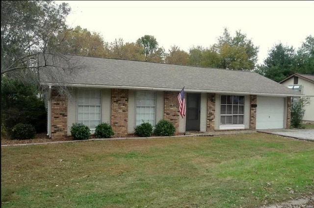 ranch-style house featuring an attached garage, brick siding, a shingled roof, driveway, and a front lawn