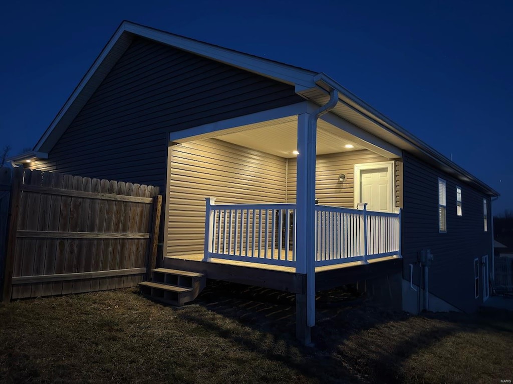 property exterior at twilight featuring fence