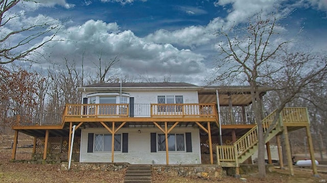 rear view of property with stairs and a deck