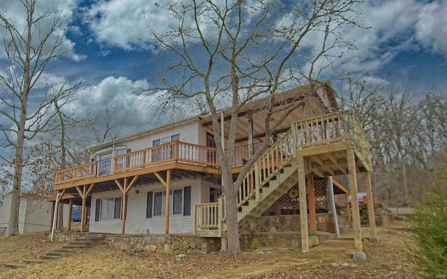 back of house featuring a wooden deck and stairs