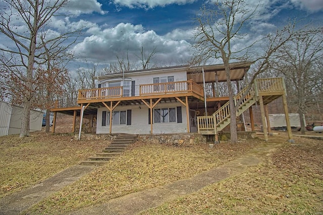 rear view of property with a wooden deck and stairway