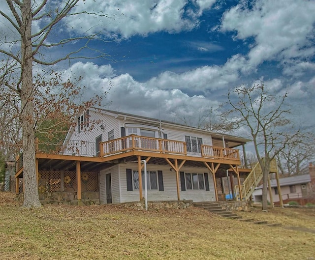 rear view of property with a wooden deck and stairs