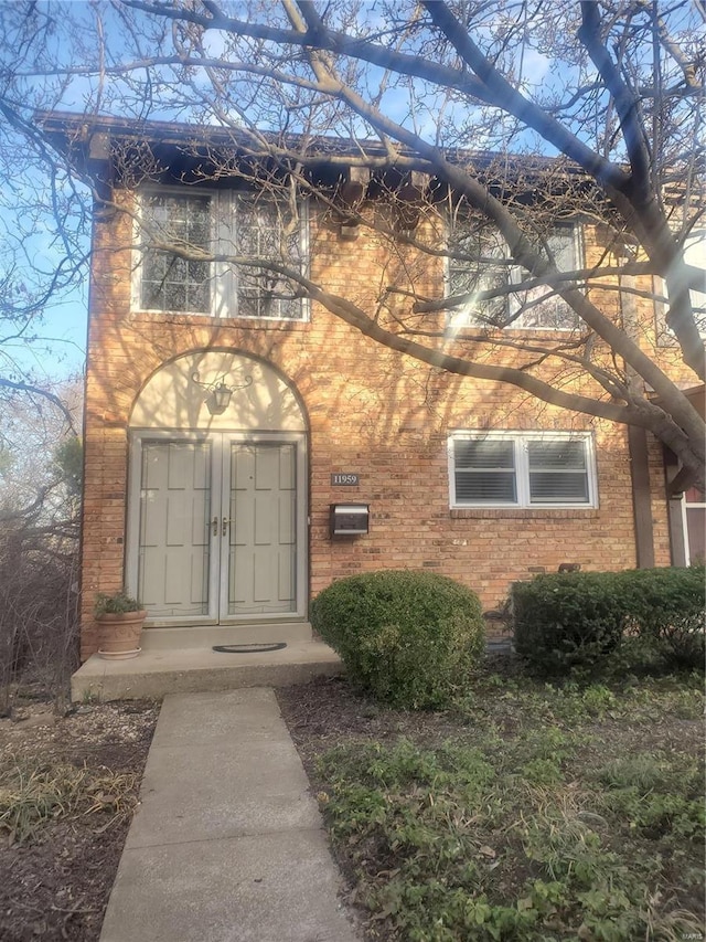 property entrance with brick siding