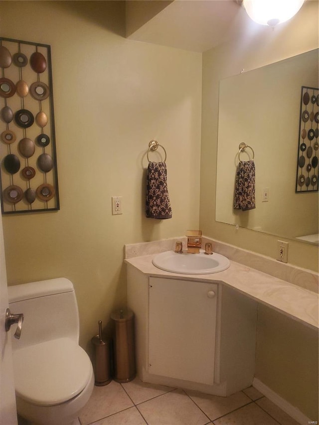 half bath with tile patterned flooring, vanity, and toilet