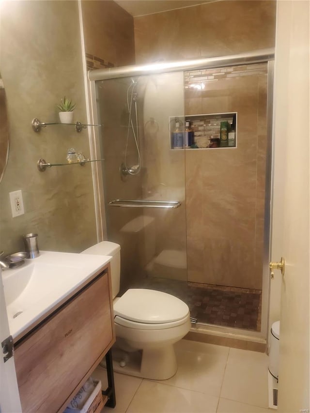 full bath featuring toilet, a shower stall, and tile patterned floors