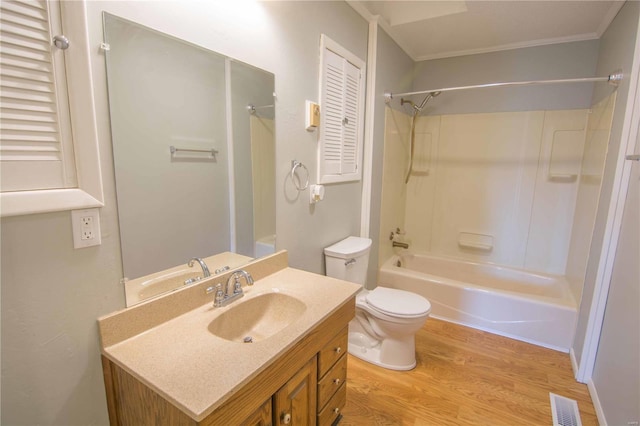 bathroom with toilet, wood finished floors, vanity, visible vents, and tub / shower combination