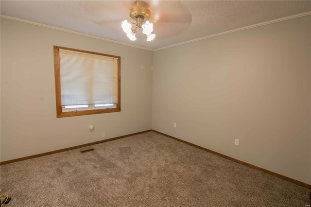 carpeted empty room featuring baseboards, visible vents, ceiling fan, ornamental molding, and a textured ceiling