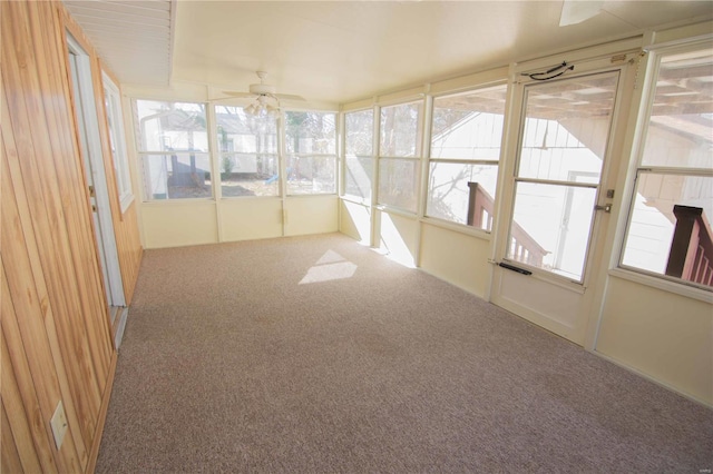 unfurnished sunroom with a ceiling fan and a healthy amount of sunlight