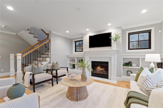 living area featuring recessed lighting, ornamental molding, stairway, and wood finished floors