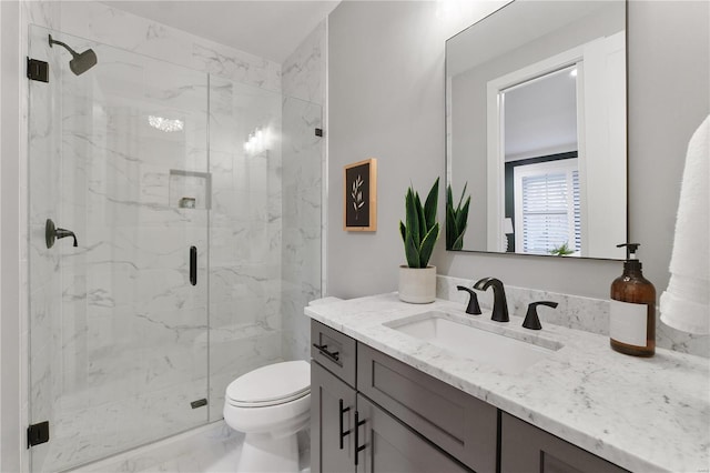 bathroom featuring a marble finish shower, marble finish floor, toilet, and vanity