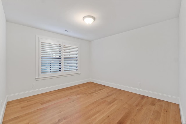 unfurnished room featuring visible vents, baseboards, and light wood-style flooring