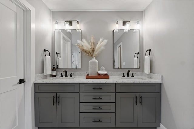 full bathroom with double vanity and a sink