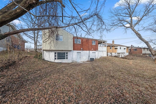 rear view of property featuring central air condition unit and fence