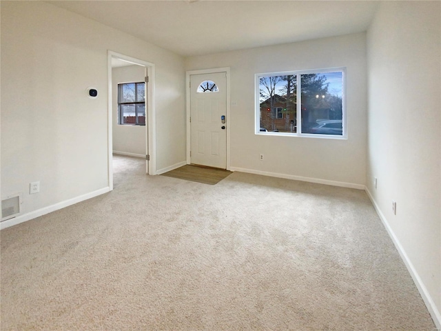 entrance foyer featuring visible vents, baseboards, and carpet flooring