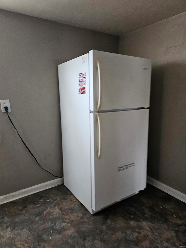 kitchen featuring freestanding refrigerator and baseboards