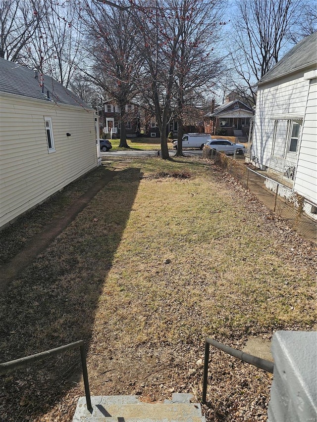 view of yard with a residential view and fence