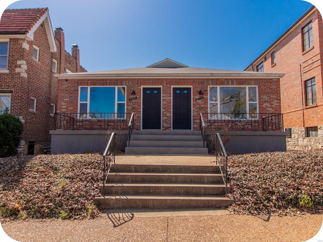 view of front of property featuring brick siding and a porch