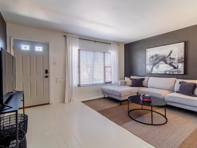 living room featuring baseboards and wood finished floors