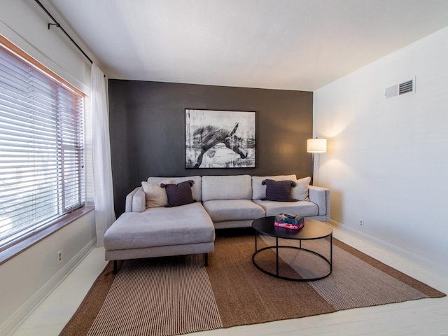 living area featuring visible vents and baseboards