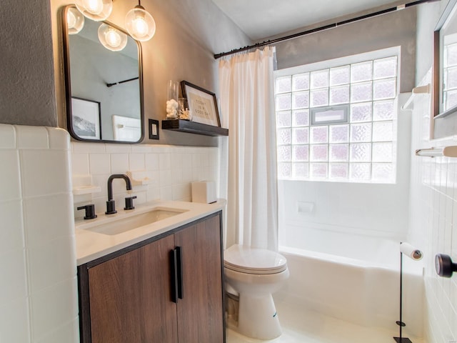 full bath with vanity, tile walls, toilet, and shower / bathtub combination with curtain