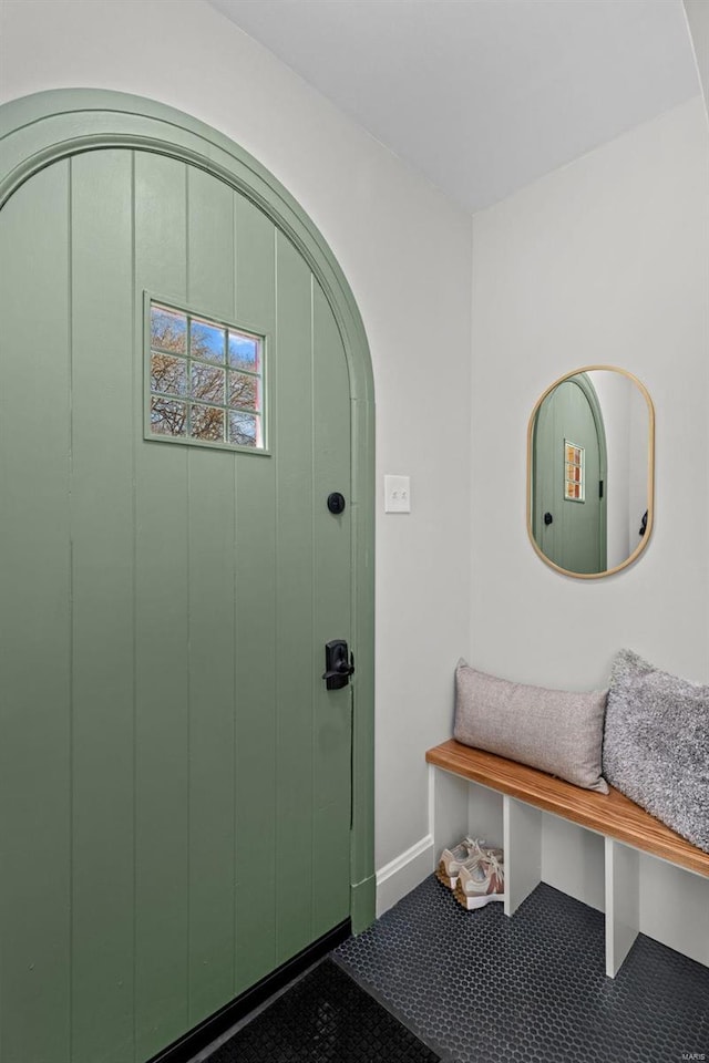 carpeted entryway featuring baseboards