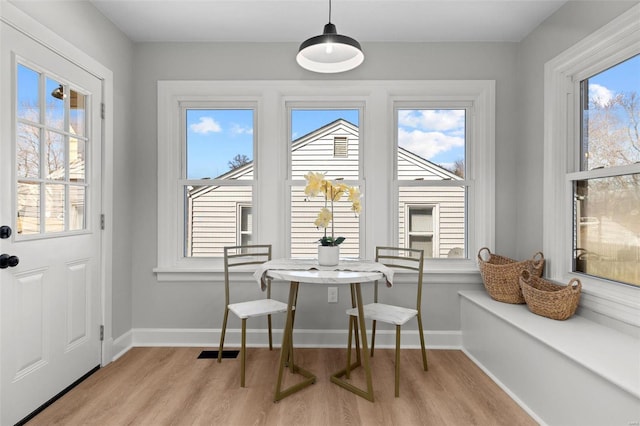 dining space featuring wood finished floors, baseboards, and a healthy amount of sunlight