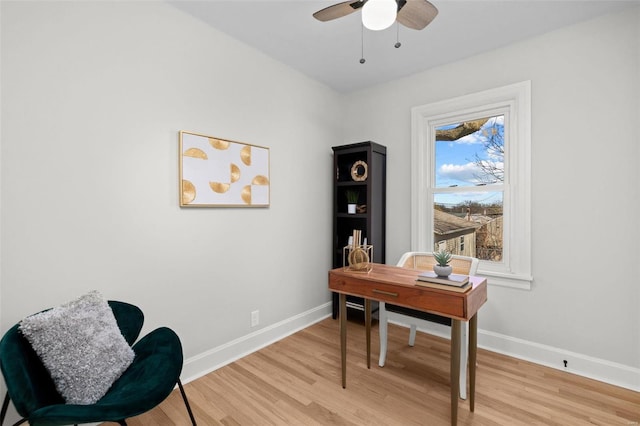 home office with light wood-type flooring, baseboards, and ceiling fan