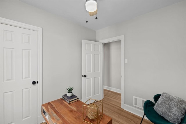 office area with visible vents, baseboards, and light wood finished floors