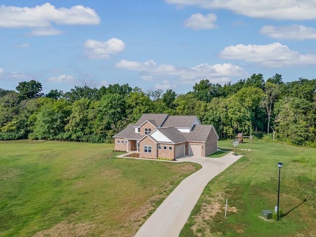 drone / aerial view featuring a wooded view