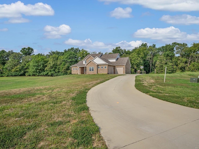 view of front facade with an attached garage, concrete driveway, and a front yard