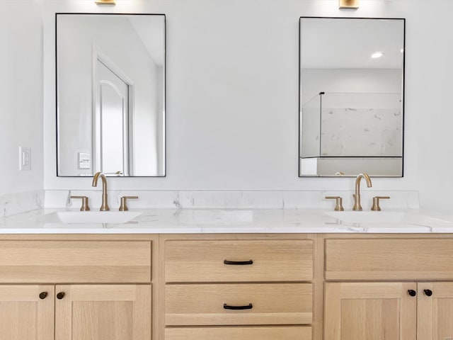 bathroom with a sink and double vanity