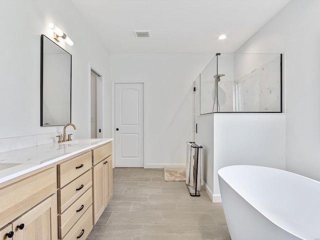 full bathroom featuring visible vents, double vanity, a freestanding bath, a sink, and a walk in shower