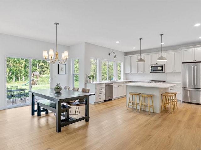 interior space featuring light wood finished floors, a chandelier, and recessed lighting