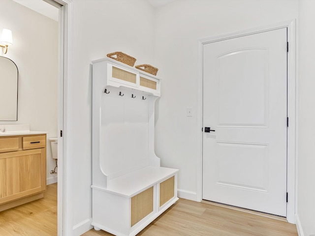 mudroom featuring baseboards and light wood finished floors