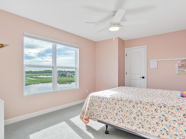 carpeted bedroom featuring a ceiling fan and baseboards