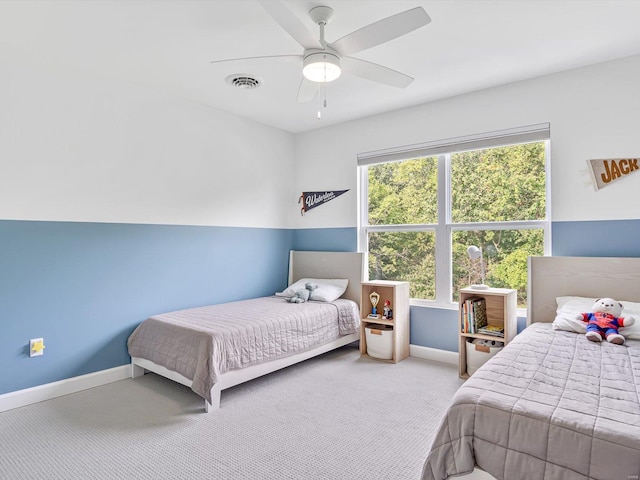 carpeted bedroom featuring visible vents, ceiling fan, and baseboards