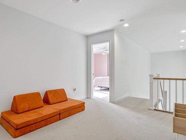 living area with an upstairs landing, recessed lighting, baseboards, and carpet