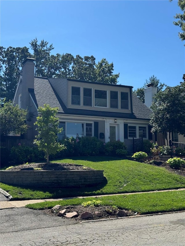 view of front of property featuring a front yard and a chimney