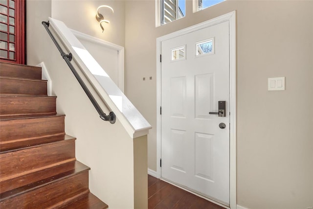 entryway featuring stairs and dark wood-style flooring