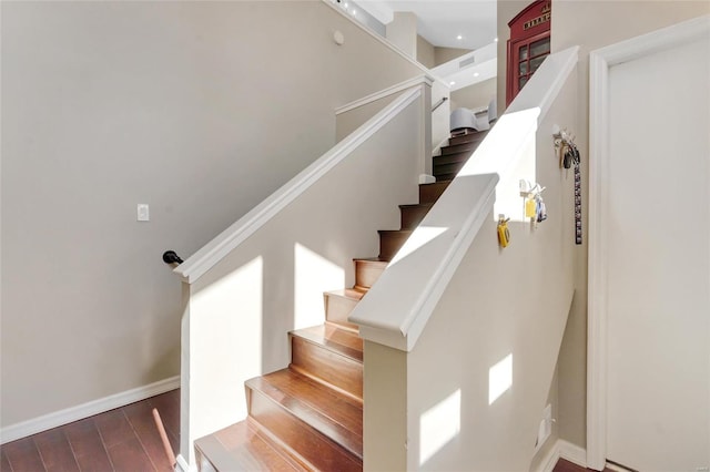 stairs with baseboards and wood finished floors