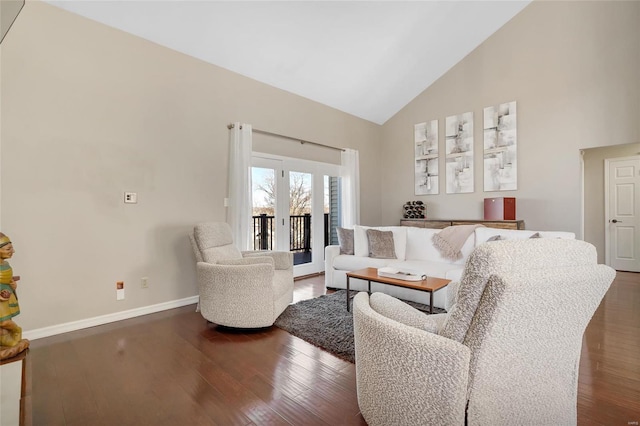 living area featuring baseboards, high vaulted ceiling, and wood finished floors