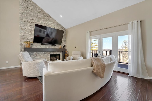 living room with dark wood finished floors, a fireplace, high vaulted ceiling, and baseboards