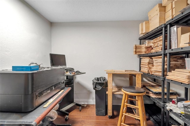 office with a textured ceiling, baseboards, and wood finished floors