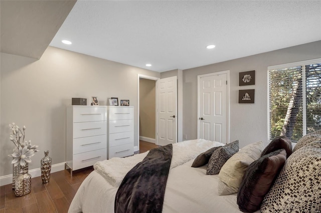 bedroom featuring recessed lighting, dark wood-style floors, and baseboards