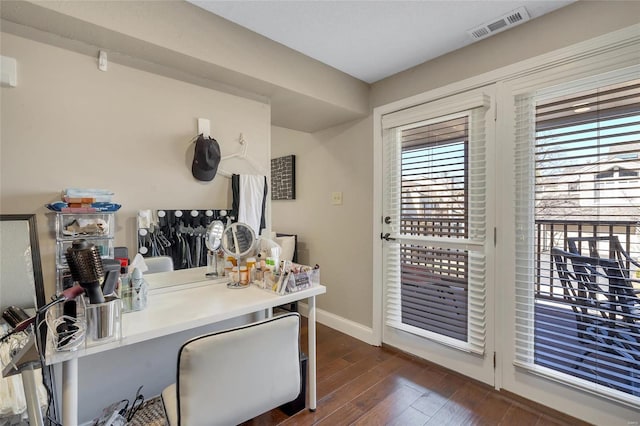 office area with baseboards, visible vents, and dark wood-style flooring